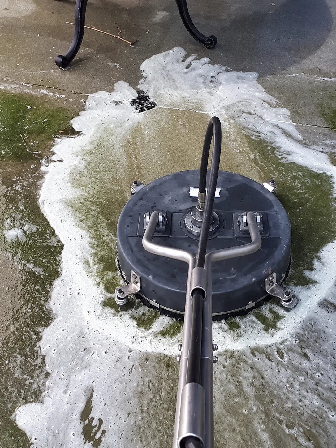 Surface cleaning with a circular pressure-washing tool.